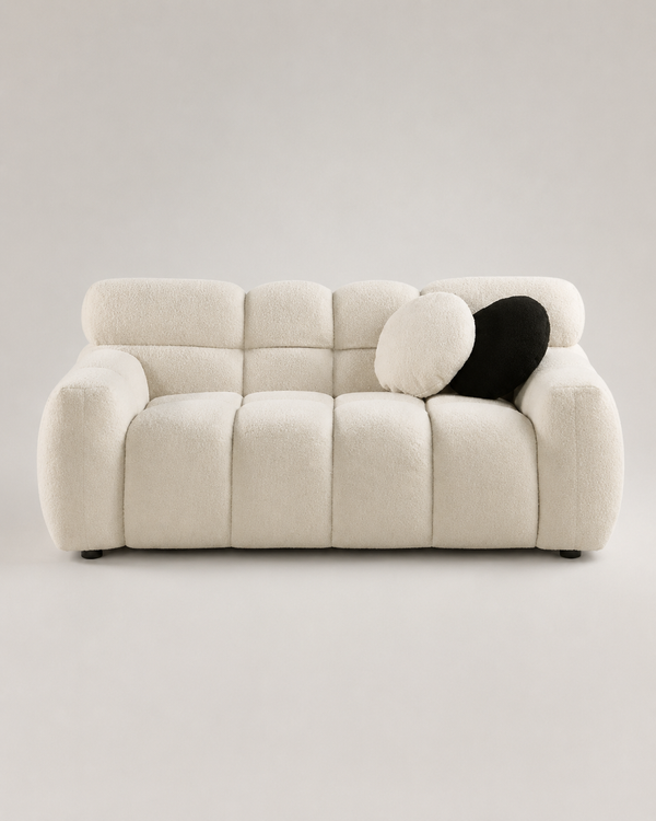 Aurelia Bouclé Sofa in warm ivory bouclé upholstery with a curved modern silhouette on a premium light grey studio background.