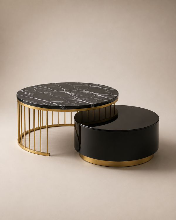 Two modern nesting coffee tables on a warm beige studio background. The larger table has a black marble top with white veining and a gold metal frame, while the smaller table is glossy black with a gold base.