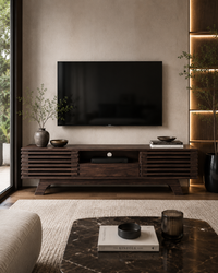 A modern dark wood TV stand and matching wall-mounted television in a styled living room with neutral beige walls, a marble coffee table, and warm ambient lighting.