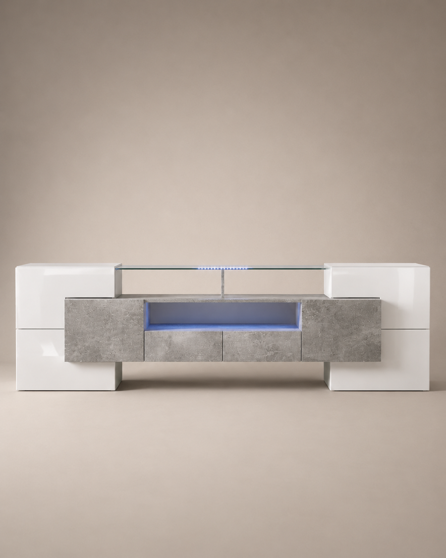 A modern low-profile media console with a glossy white high-gloss finish, textured gray stone-look front panels, and a glass top shelf illuminated by blue LED lighting, set against a neutral beige background.