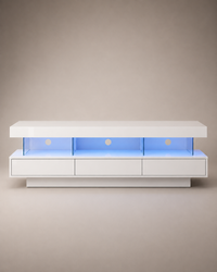 A modern white floating media console with three open shelves illuminated by blue LED lighting, set against a neutral beige background.