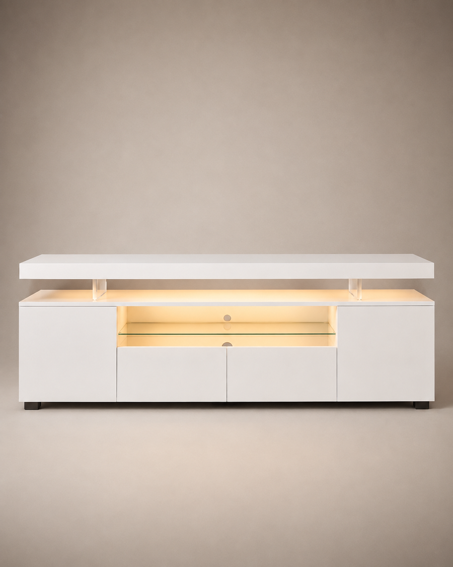 A modern white media console with a lift-top design, illuminated by warm yellow LED lighting inside. The cabinet features two side cabinets, two central drawers, and a glass shelf in the center, supported by clear acrylic pillars under the top surface.