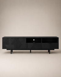 A modern black wooden media console with geometric carved panel details and open shelving, shown against a neutral beige background.