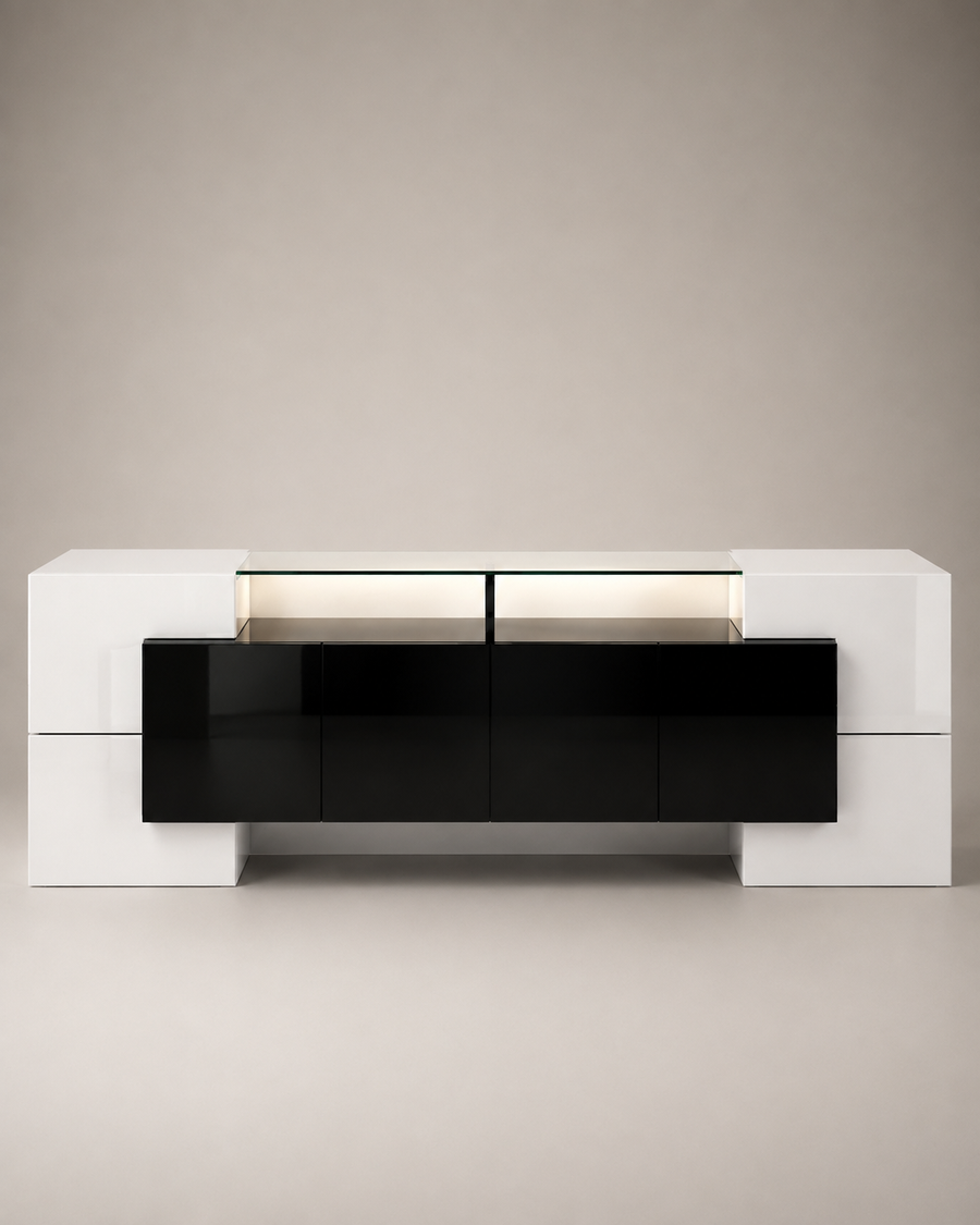 A modern low-profile media console with a glossy black front and white side cabinets, set against a neutral beige background.