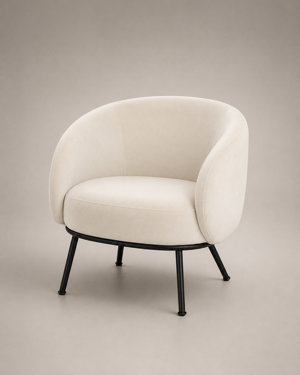 A modern barrel-style armchair with a curved cream upholstered seat and back, supported by slim black metal legs, set against a neutral warm gray studio background.