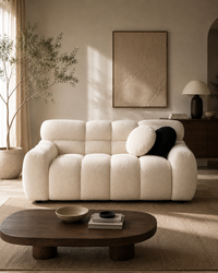Aurelia Bouclé Sofa styled in a luxury contemporary living room with warm natural daylight and modern architectural interiors.