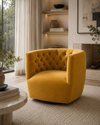 A modern mustard yellow tufted velvet armchair in a beautifully styled living room with a fireplace, built-in shelves, and a marble side table.