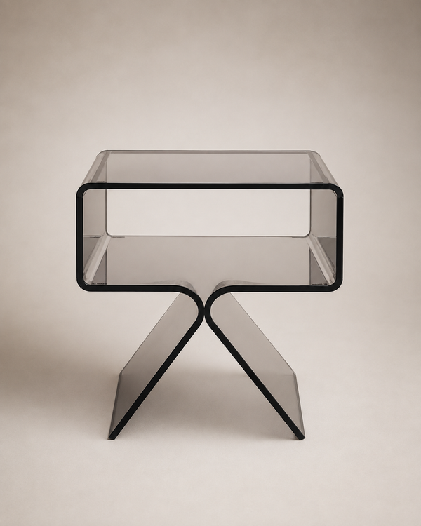 A modern translucent side table with a rectangular top and sculptural intersecting legs, shown on a plain warm gray studio background.