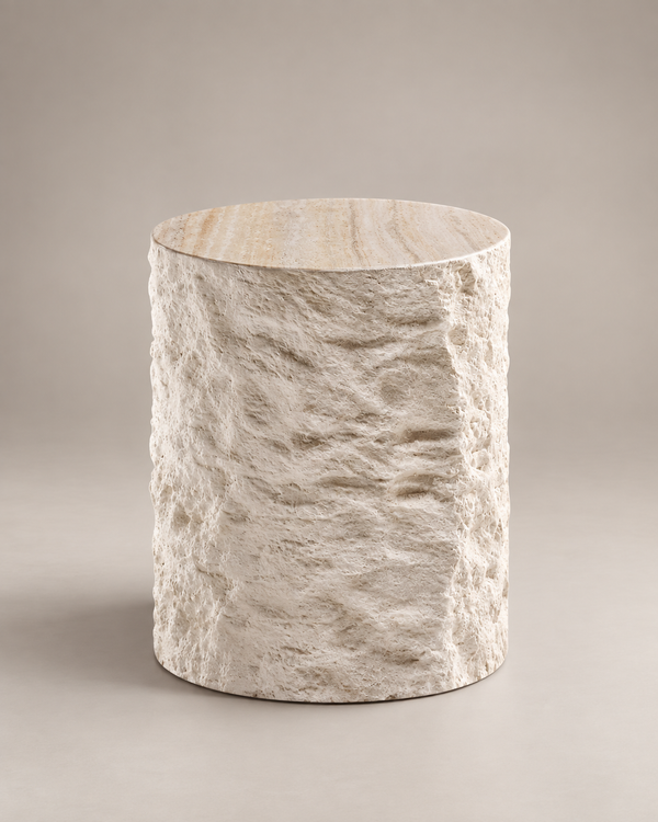 A cylindrical side table with a textured, stone-like beige and cream finish, shown on a neutral warm gray background.