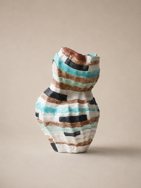 A handmade ceramic vase with a textured, ribbed surface decorated with horizontal hand-painted stripes in turquoise, brown, black, and white, set against a solid beige background.