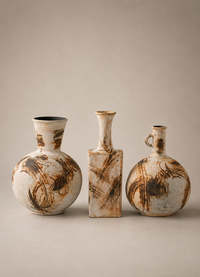Three handmade ceramic vases with abstract brown and cream painted patterns, displayed on a neutral beige background.