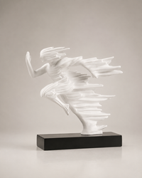 A white abstract figurative sculpture of a dancing or flying human form mounted on a rectangular black base, photographed against a plain light gray studio background.