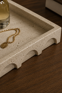Close-up of Aurevia decorative tray showing textured travertine-inspired finish and sculpted arch detailing