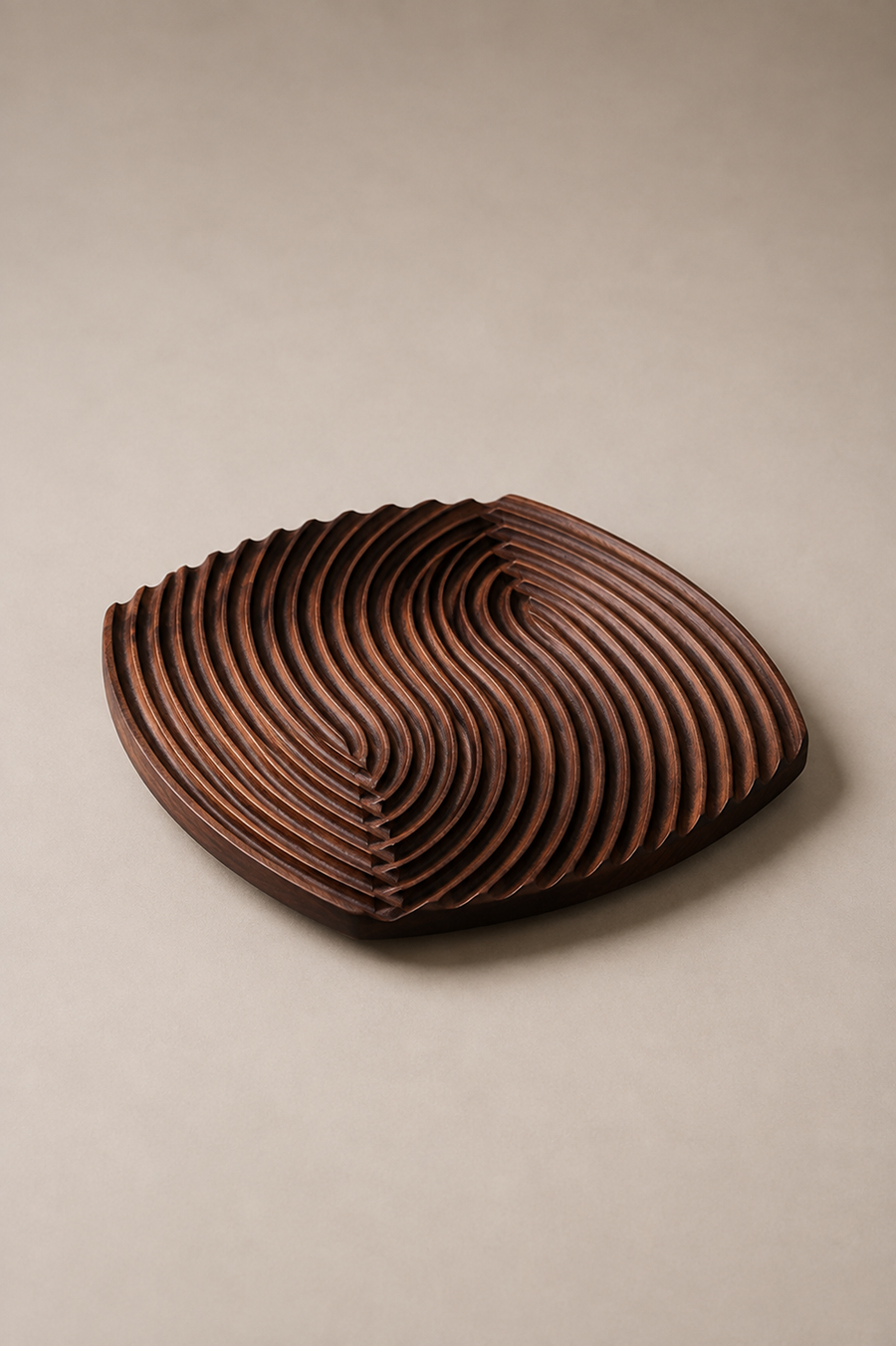 A dark brown wooden serving tray with a sculptural, layered wavy design, photographed on a neutral beige background.