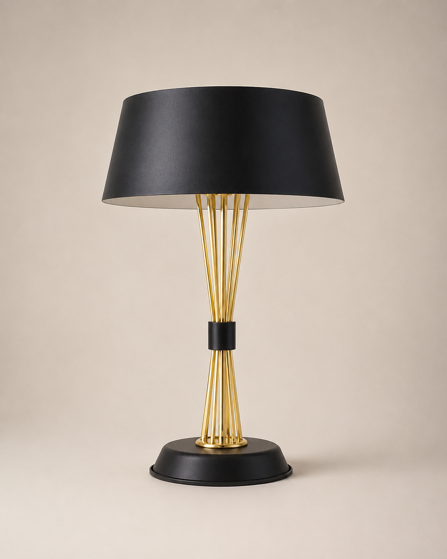 A modern table lamp with a matte black conical shade, a gold-finished wire stem structure, and a black circular base, set against a solid beige background.