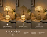 A three-panel product demonstration showing a crystal table lamp in three lighting modes: top and bottom on, bottom only on, and top only on. The lamp features a gold-finished base and a dome-shaped crystal shade that glows warm yellow.