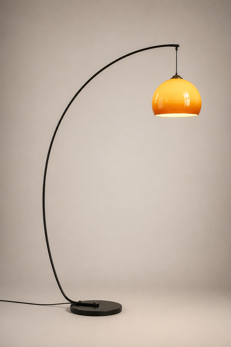 Solenne Arc Glass Floor Lamp with sweeping black frame and amber glass shade