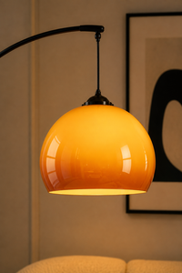 Close-up of Solenne Floor Lamp amber glass shade and black suspension detail