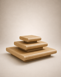 Three nested square wooden platforms or pedestals in varying sizes, made from light natural wood with rounded edges, set against a plain beige background.