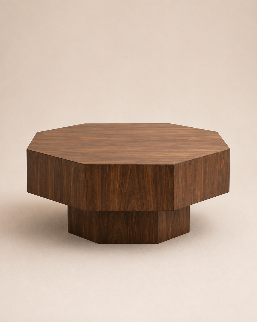 A modern octagonal wooden coffee table with a dark walnut finish, featuring a tiered design with a thick top and a solid pedestal base, set against a warm beige background.